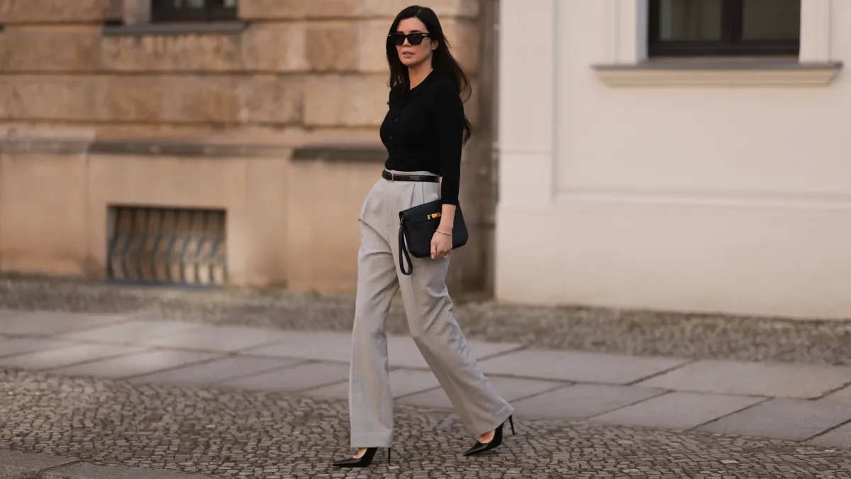 woman in black top and gray trousers