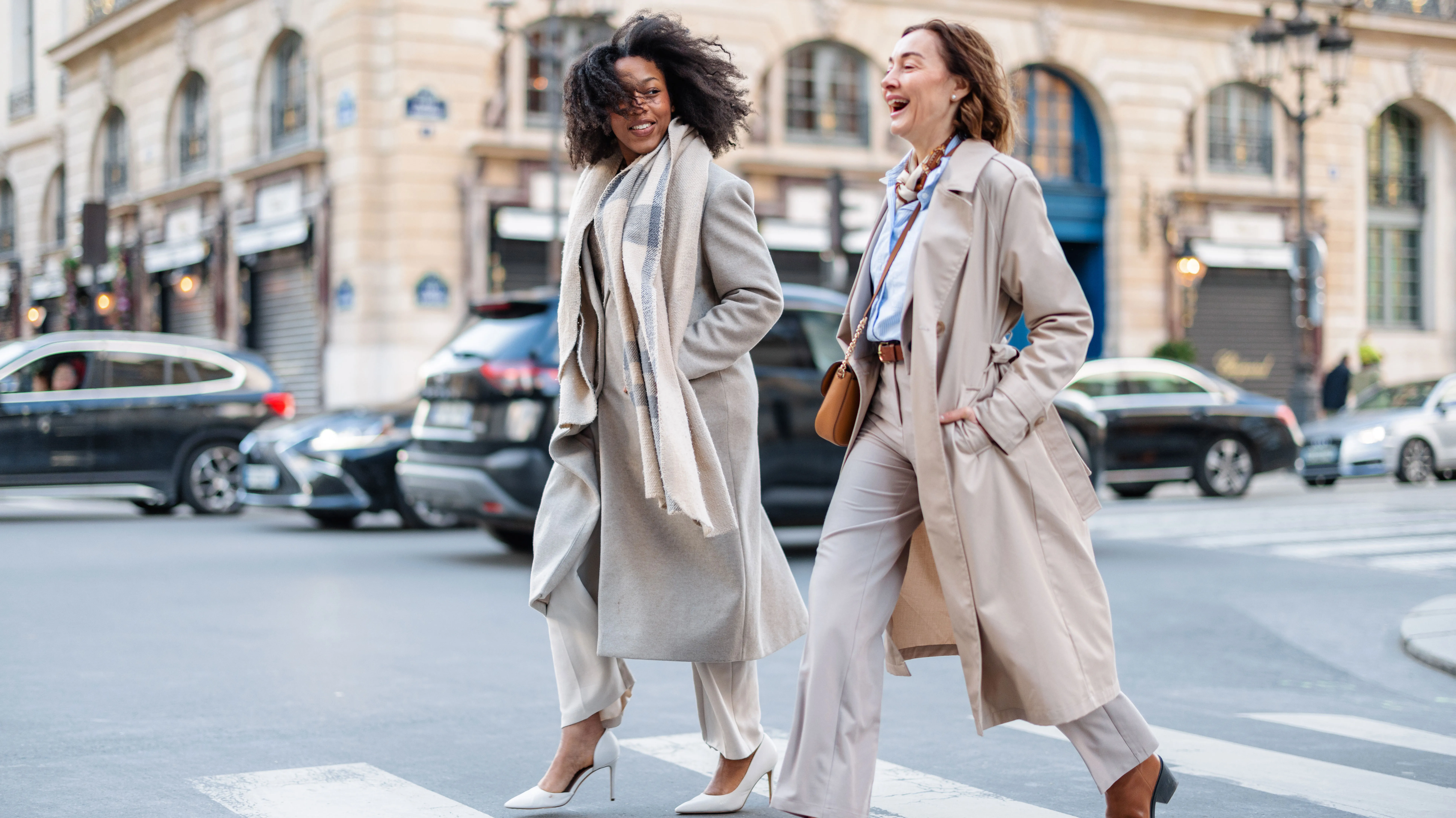Mature Caucasian And Young Black Businesswomen Confidently Crossing City Street - stock photo