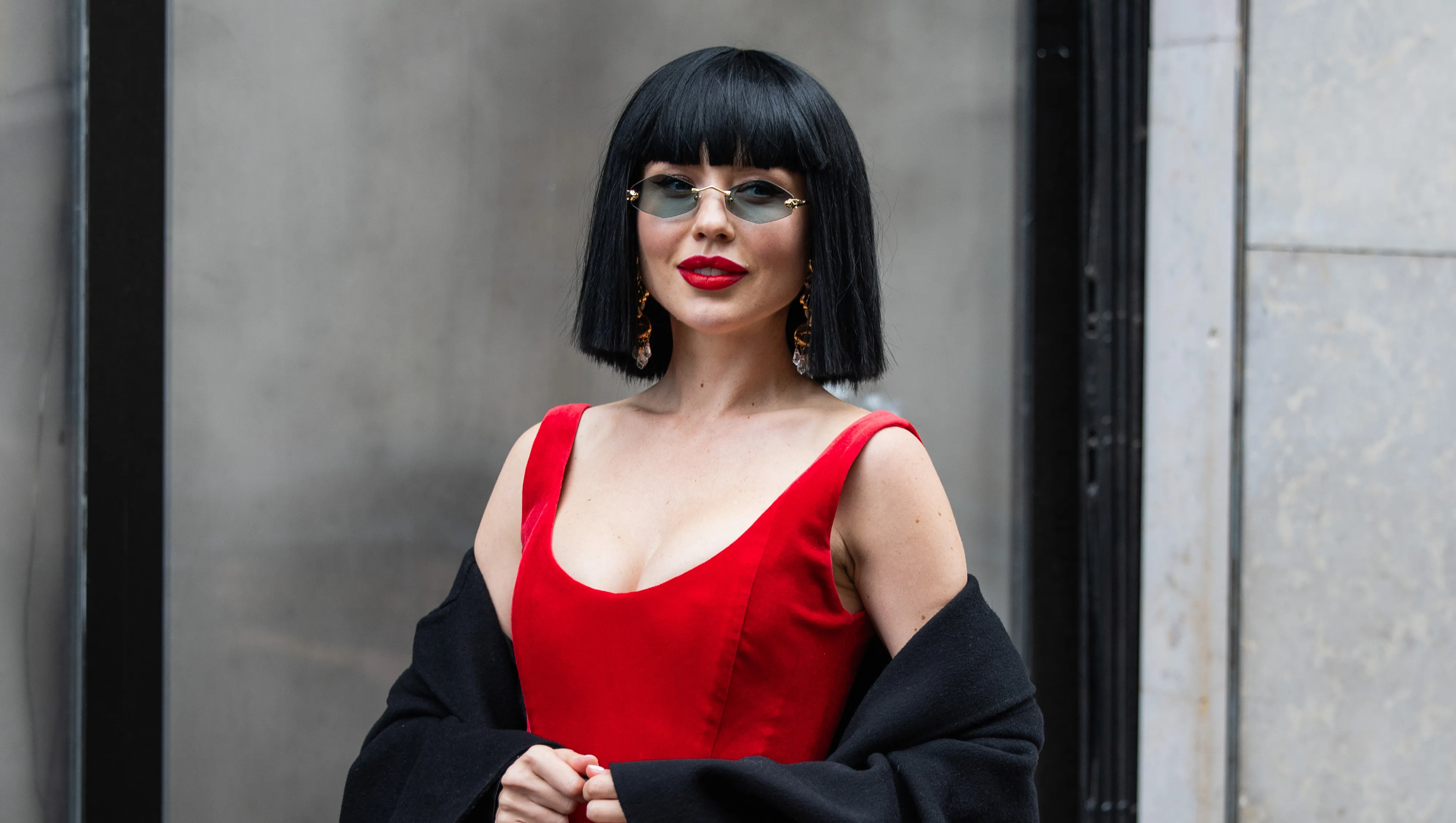 PARIS, FRANCE - JANUARY 28: A guest wears red dress, black Dolce & Gabbana bag outside Stephane Rolland during Haute Couture Spring-Summer 2025 as part of Paris Fashion Week on January 28, 2025 in Paris, France. (Photo by Christian Vierig/Getty Images)