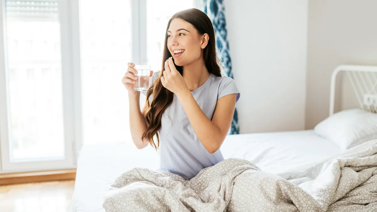 Healthy young woman taking supplements