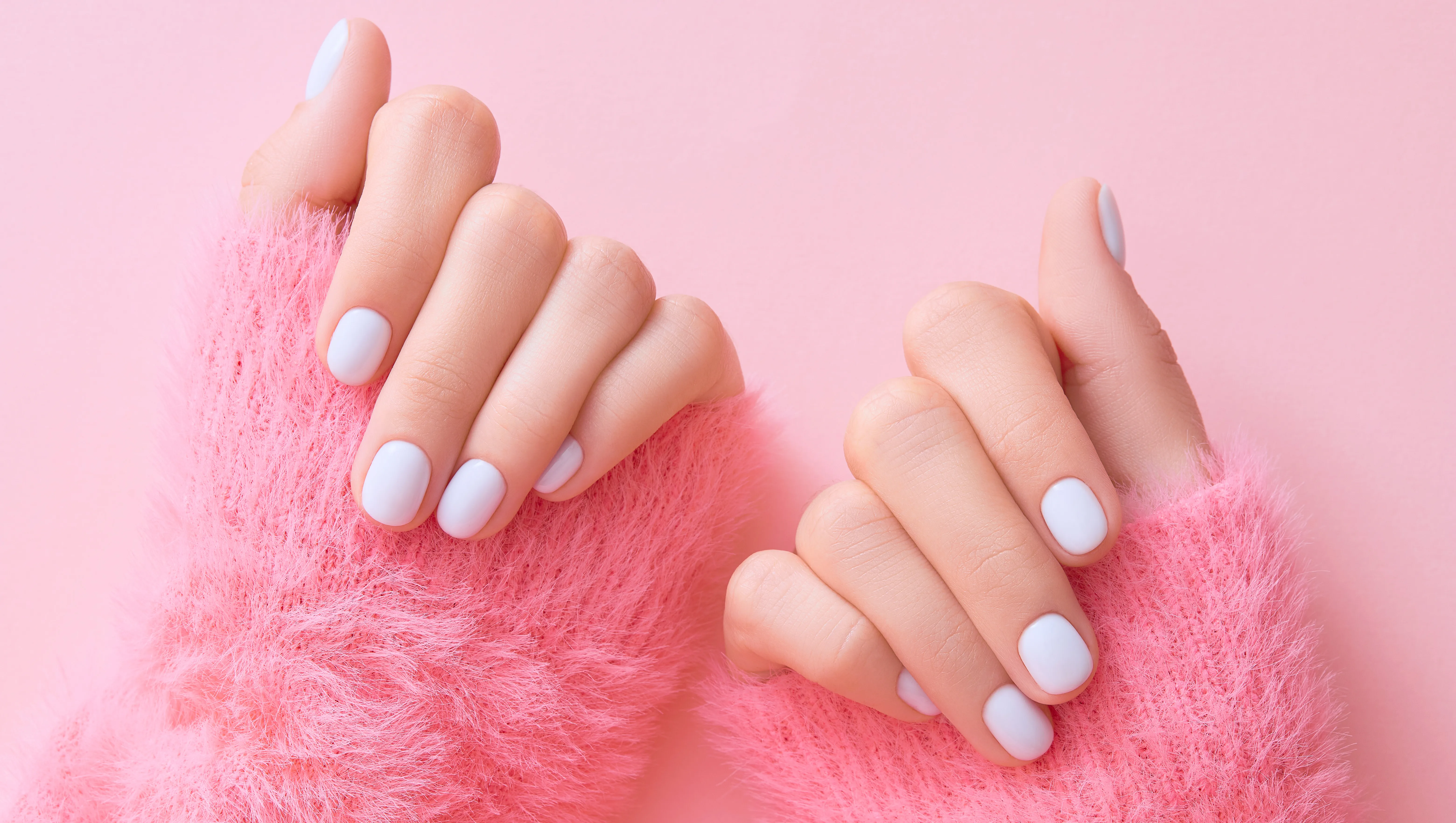 Close up womans hands with white manicure