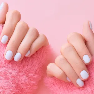 Close up womans hands with white manicure