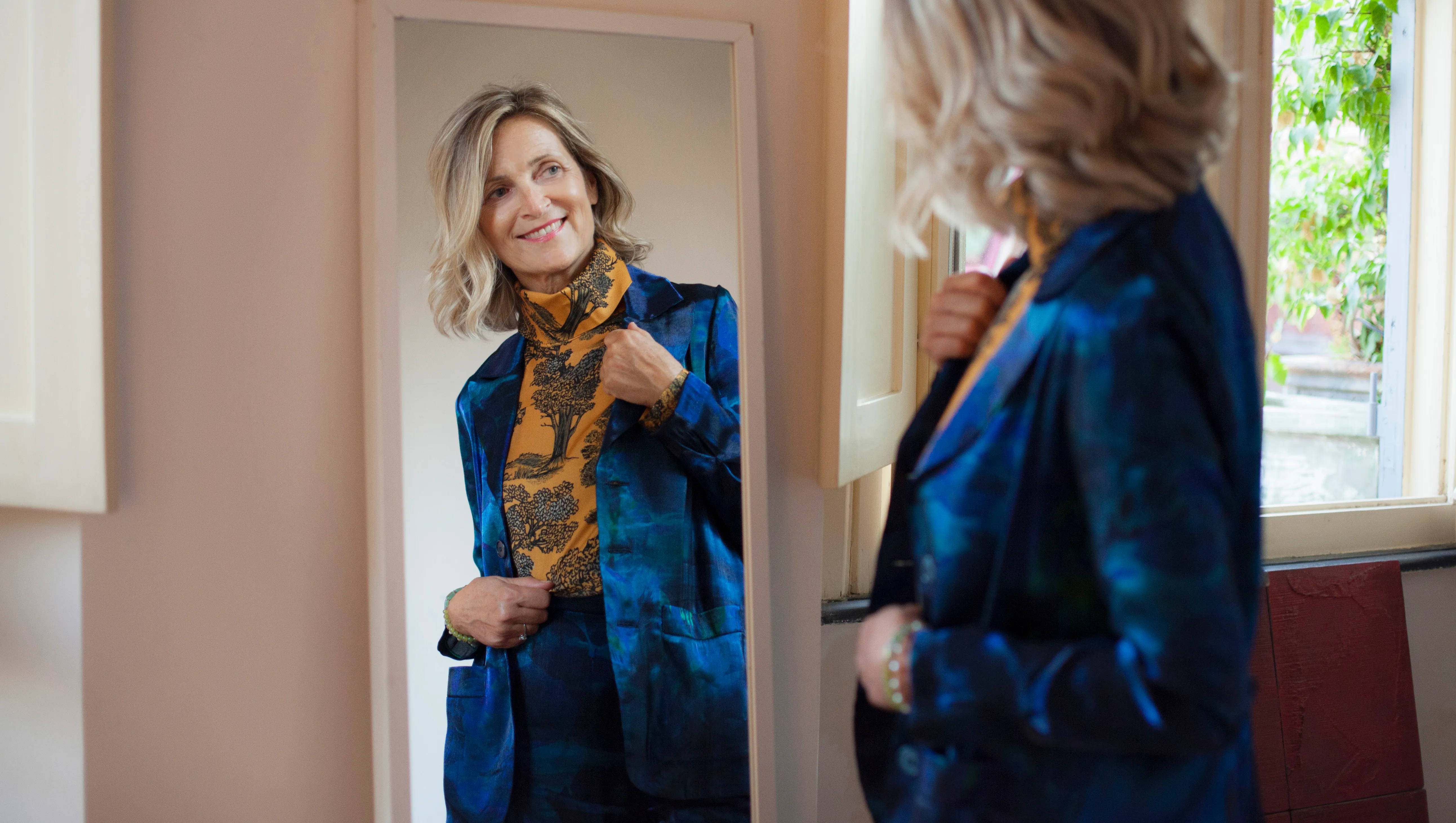 Beautiful mature woman checking herself in the mirror