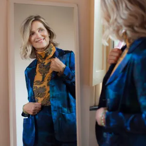 Beautiful mature woman checking herself in the mirror