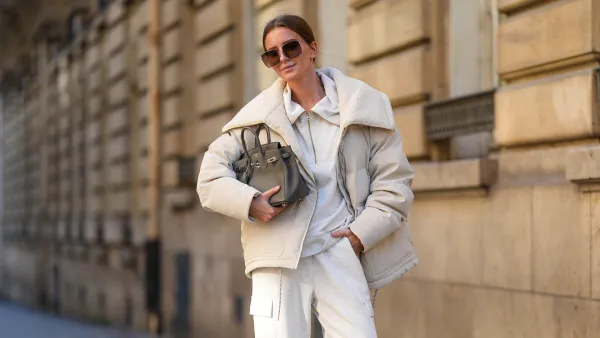 PARIS, FRANCE - OCTOBER 23: Diane Batoukina wears black Dior sunglasses, a white Varley puffer jacket, a white Adidas sweatshirt, white Varley pants, a grey leather Birkin Hermes bag, white socks, white Samba Adidas sneakers shoes, during a street style fashion photo session, on October 23, 2024 in Paris, France. (Photo by Edward Berthelot/Getty Images)
