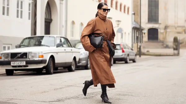 COPENHAGEN, DENMARK - JANUARY 31: Gili Biegun wears, long brown leather coat, black bag, black long leather gloves, sunglasses and black shoes during the Copenhagen Fashion Week Autumn/Winter 2025 on January 31, 2025 in Copenhagen, Denmark. (Photo by Raimonda Kulikauskiene/Getty Images)