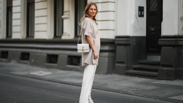 woman wearing beige sweater and white pants