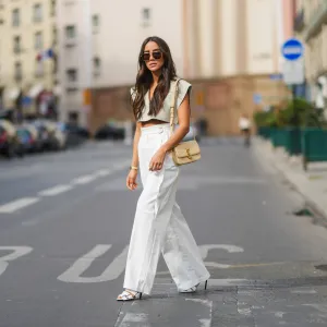 woman wearing cropped beige blouse and white pants