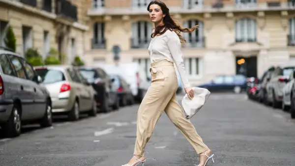 woman wearing white blouse and beige pants