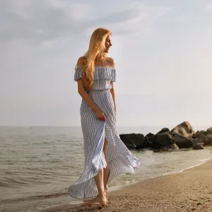 Beautiful young woman near water on sea beach