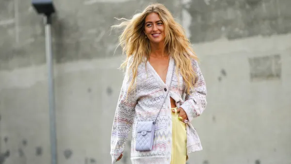 woman wearing purple cardigan and yellow pants