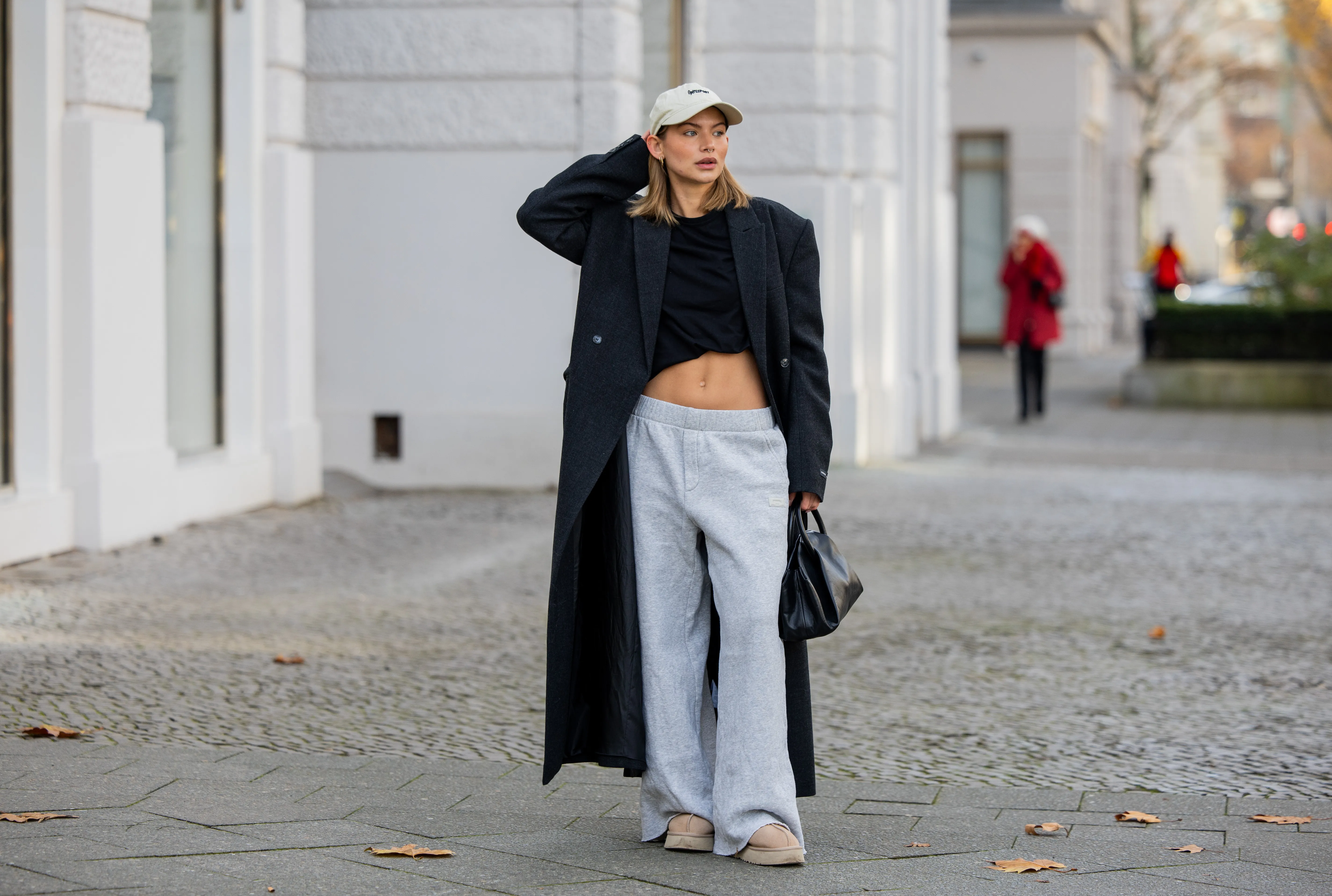 woman wearing sweatpants and trench coat