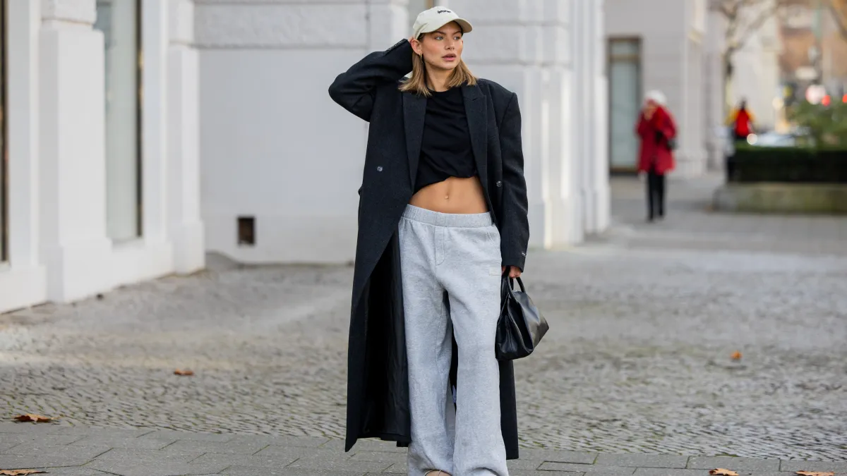woman wearing sweatpants and trench coat