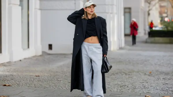 woman wearing sweatpants and trench coat
