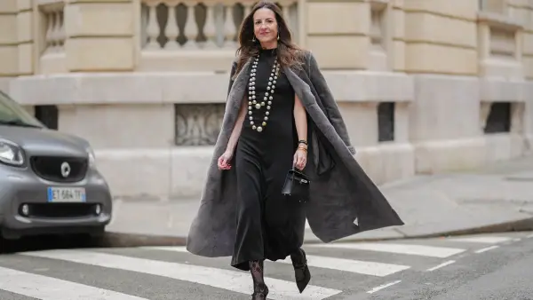 woman wearing black dress and gray coat