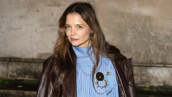 katie holmes in blue top and brown coat