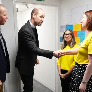 Prince William shakes a woman's hand