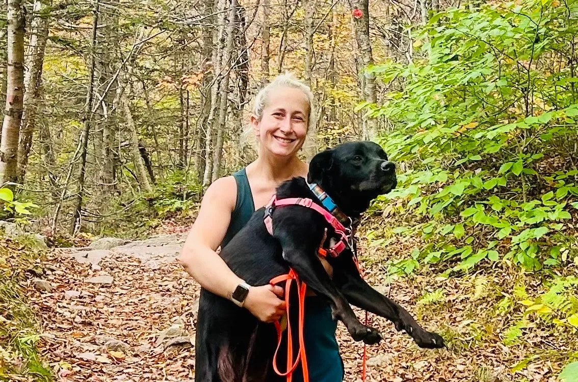 Lizzy Rosenberg and her rescue dog, Cricket on a hike