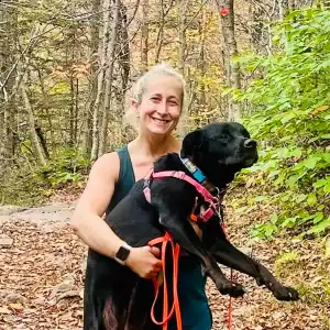 Lizzy Rosenberg and her rescue dog, Cricket on a hike