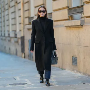 PARIS, FRANCE - JANUARY 13: Diane Batoukina wears black sunglasses, a black cashmere Zara turtleneck pullover, a black Zara coat, a grey leather Birkin Hermes bag, black / dark grey denim Massimo Dutti jeans / pants, black socks, black leather loafers, during a street style fashion photo session, on January 13, 2025 in Paris, France. (Photo by Edward Berthelot/Getty Images)