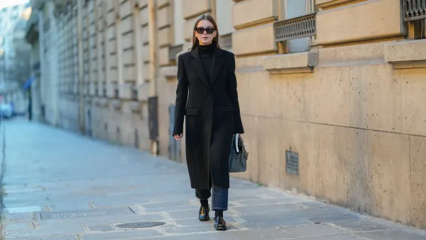 PARIS, FRANCE - JANUARY 13: Diane Batoukina wears black sunglasses, a black cashmere Zara turtleneck pullover, a black Zara coat, a grey leather Birkin Hermes bag, black / dark grey denim Massimo Dutti jeans / pants, black socks, black leather loafers, during a street style fashion photo session, on January 13, 2025 in Paris, France. (Photo by Edward Berthelot/Getty Images)
