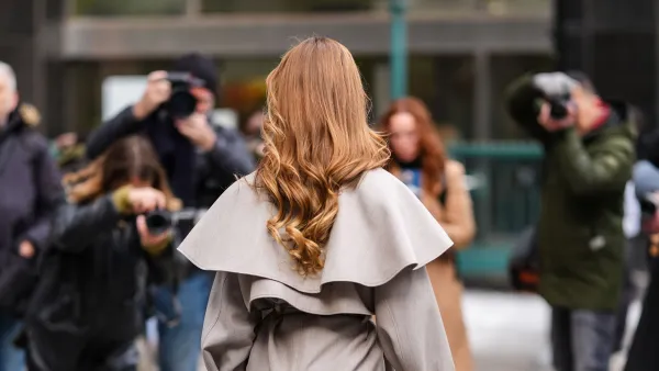 NEW YORK, NEW YORK - FEBRUARY 08: A guest wears a gray trench coat and poses in front of photographers, outside Altuzarra, during New York Fashion Week, on February 08, 2025 in New York City. (Photo by Edward Berthelot/Getty Images)
