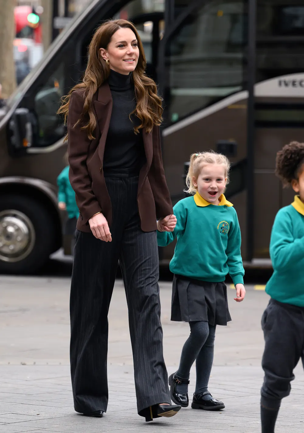 Kate Middleton Boards School Bus and Holds Hands With Children During Royal Visit