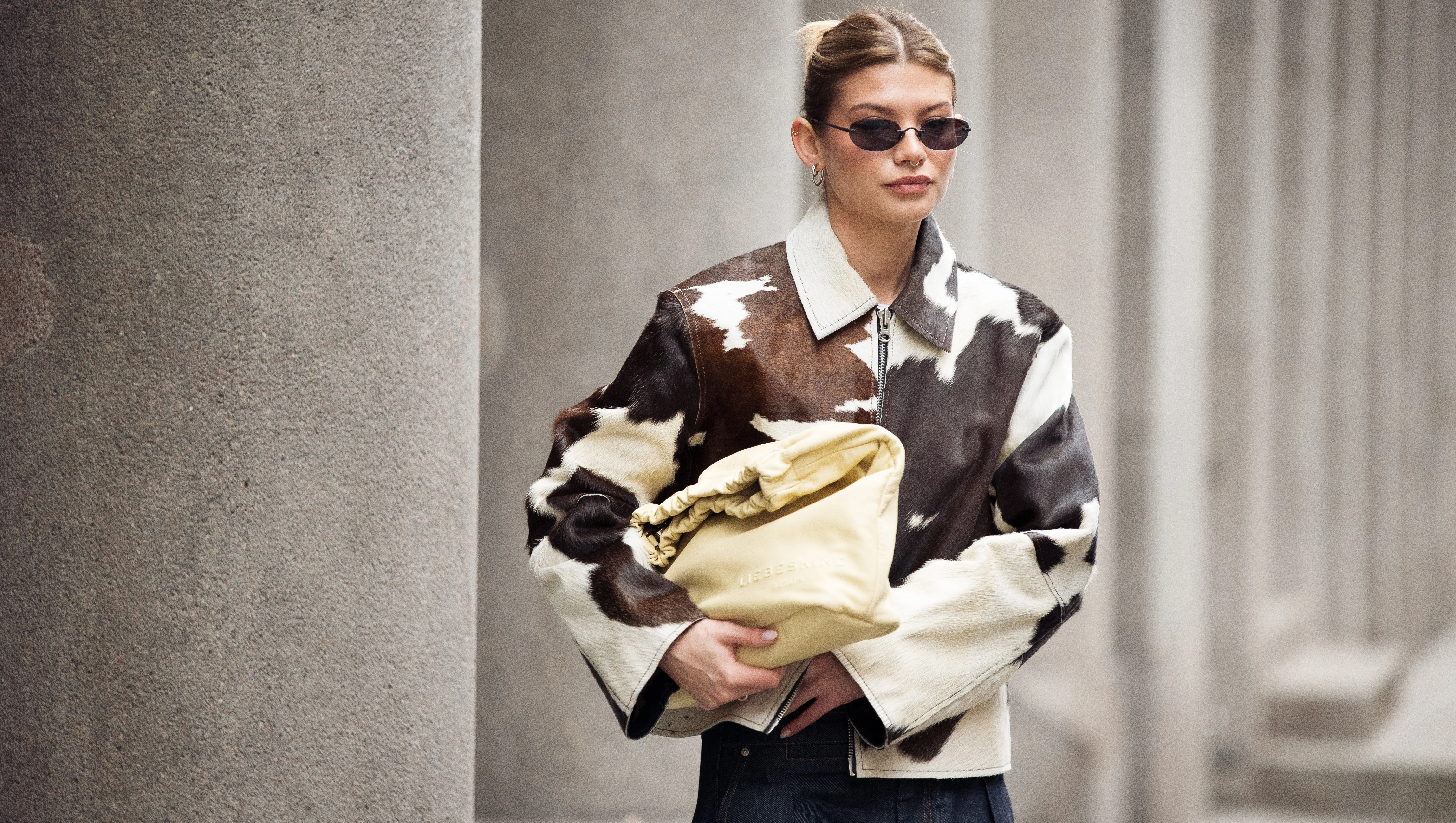COPENHAGEN, DENMARK - JANUARY 30: Sophia Geiss wears cow print cropped jacket with a zipper, pale yellow bag, blue wide jeans during the Copenhagen Fashion Week Autumn/Winter 2025 on January 30, 2025 in Copenhagen, Denmark. (Photo by Raimonda Kulikauskiene/Getty Images)