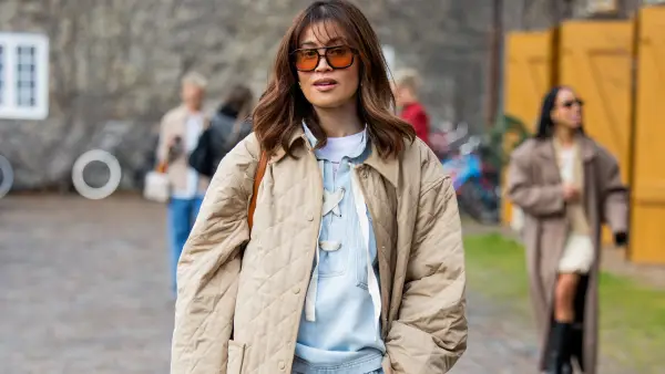 COPENHAGEN, DENMARK - JANUARY 30: Michelle Elie wears wide leg blue pants, beige jacket, top outside Munthe during the Copenhagen Fashion Week Autumn/Winter 2025 on January 30, 2025 in Copenhagen, Denmark. (Photo by Christian Vierig/Getty Images)