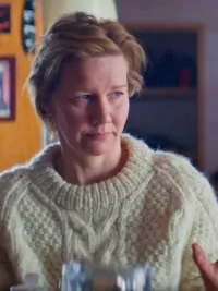 A woman holds up her hands in Anatomy of a Fall.