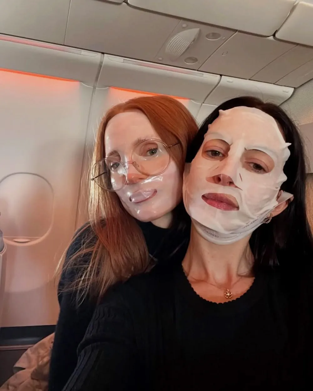 Anne Hathaway and Jessica Chastain Relax in Matching Face Masks During Joint Flight