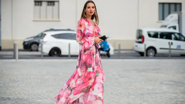 Maria Rosaria Rizzo is seen wearing a pink dress with floral print MSGM, white Furla fanny belt bag, Jonak boots during Milan Fashion Week Spring/Summer 2020 on September 18, 2019 in Milan, Italy.