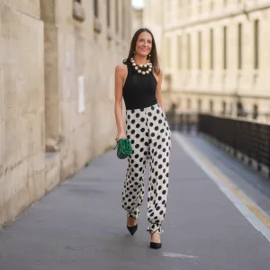 woman in black and white polka dotted pants, top and heels