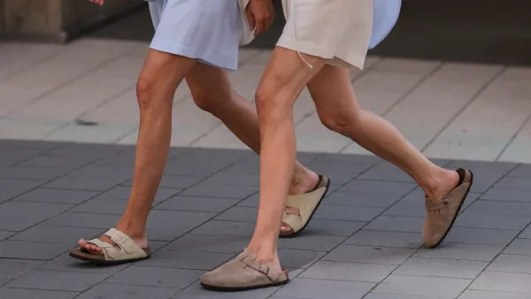 women in shorts and button up tops wearing sandals