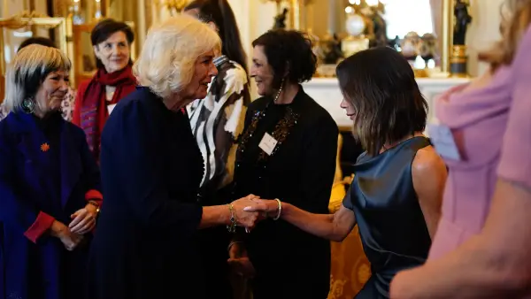 Victoria Beckham curtsies to Queen Camilla