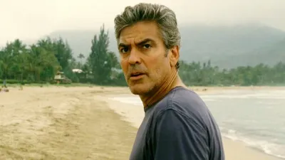 George Clooney looks back on a beach in The Descendants.