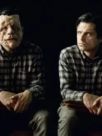 Two men sit in A Different Man.