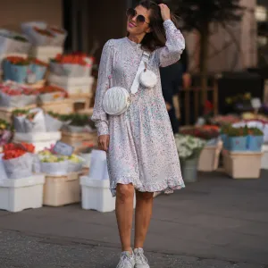 woman wearing floral dress with sneakers
