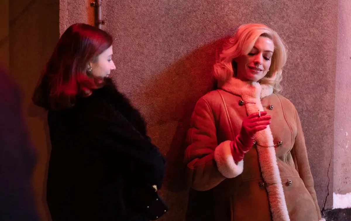 Two women stand outside and talk in Eileen.