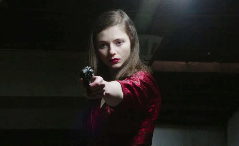 A girl aims a gun in Eileen.