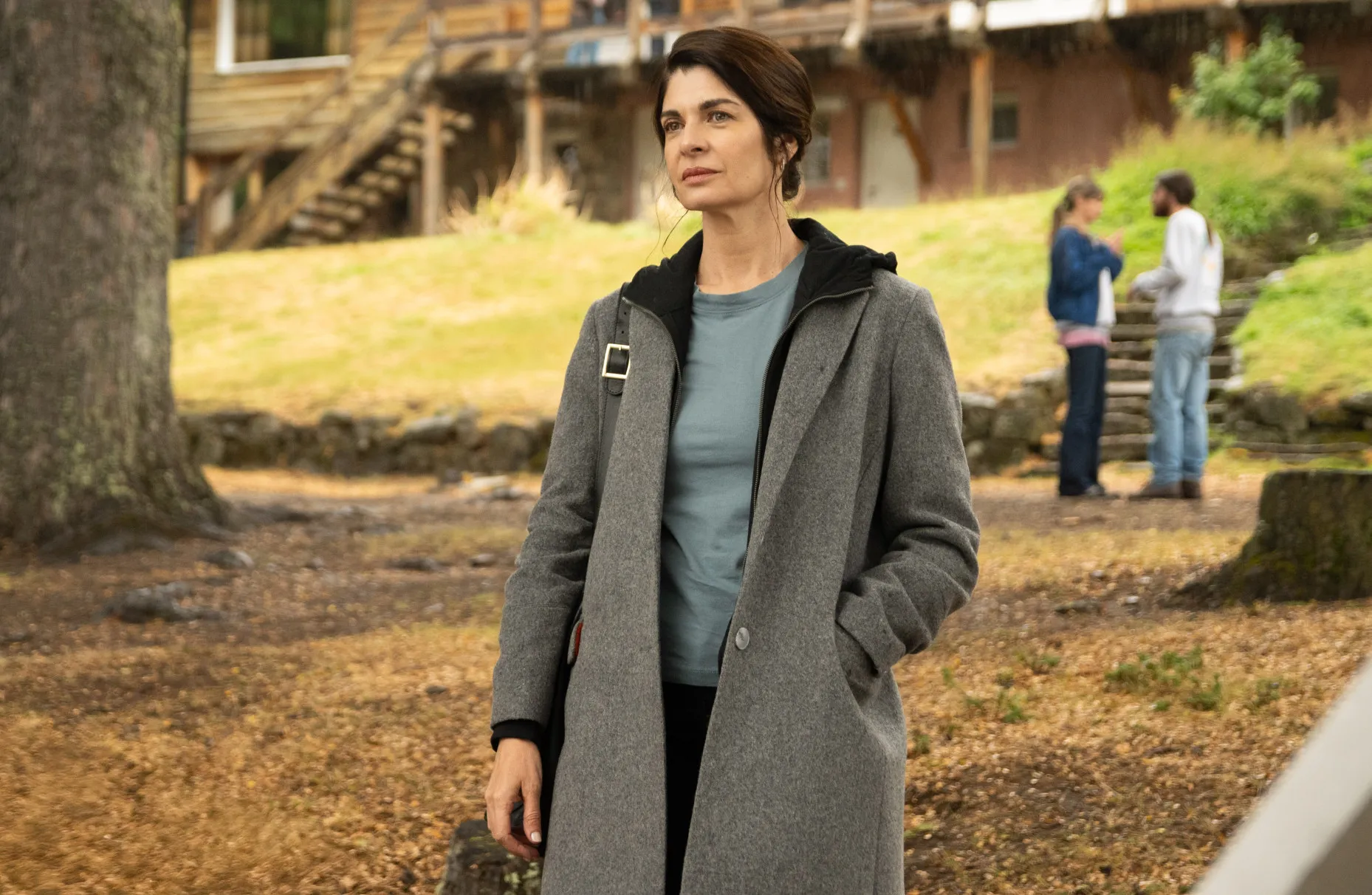 A woman stands outside in Caught.