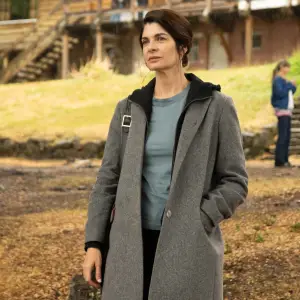 A woman stands outside in Caught.