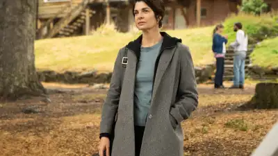 A woman stands outside in Caught.