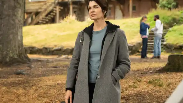 A woman stands outside in Caught.