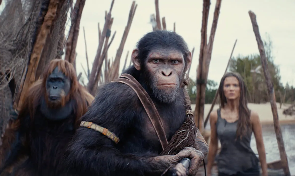Two apes and a human woman prepare for battle in Kingdom of the Planet of the Apes.