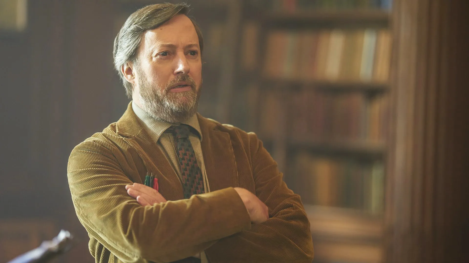 A man crosses his arms in Ludwig.