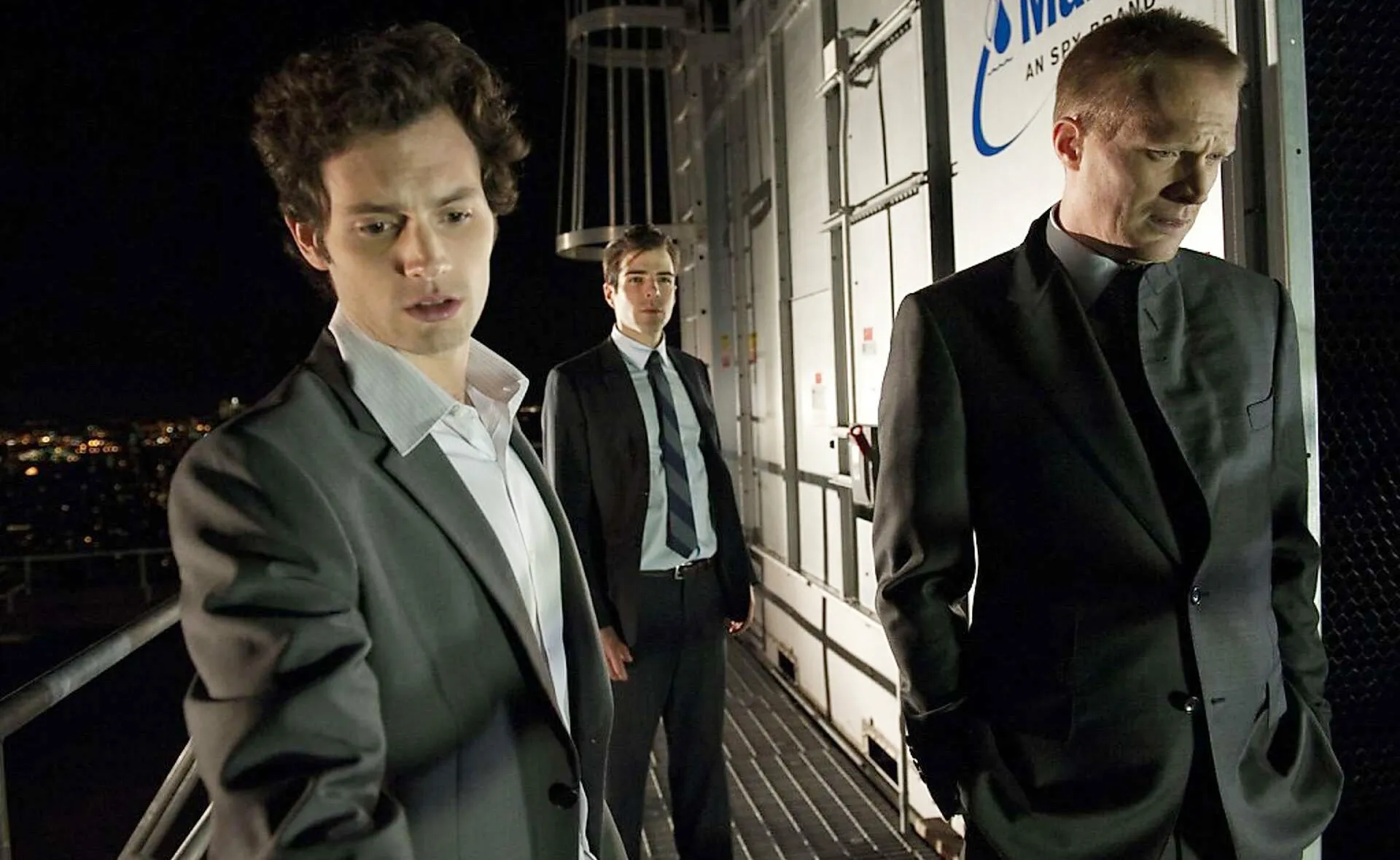 Three men stand on a roof at night in Margin Call.