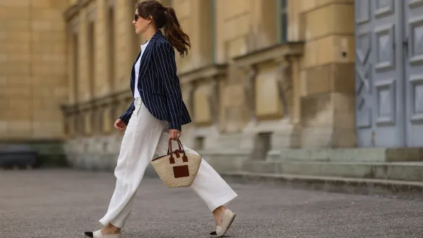 woman in navy blazer and white pants