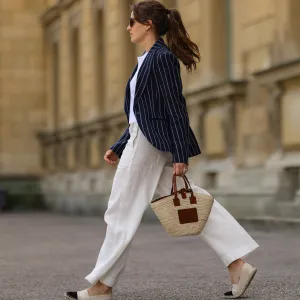 woman in navy blazer and white pants
