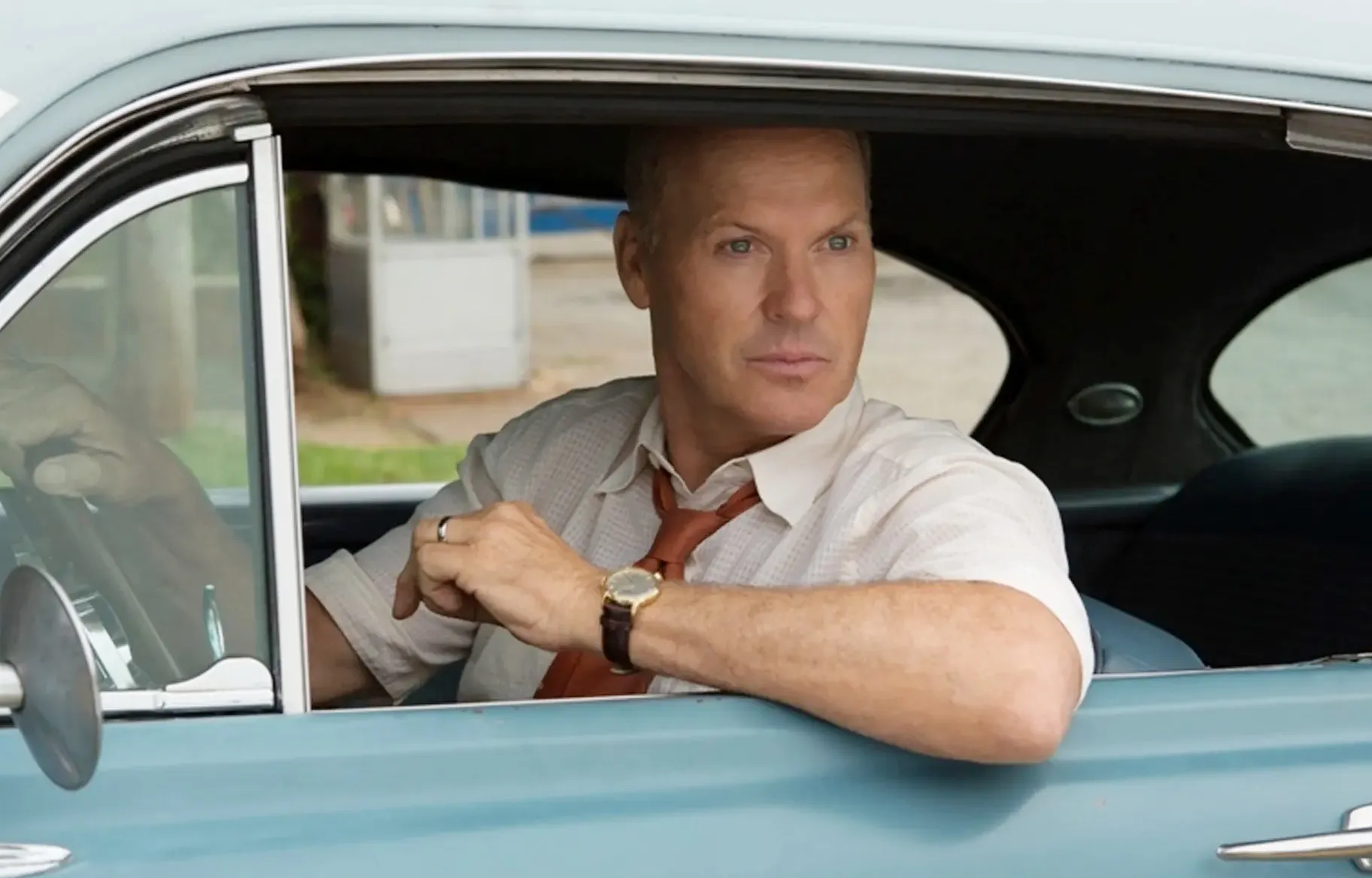 A man leans out of a car in The Founder.